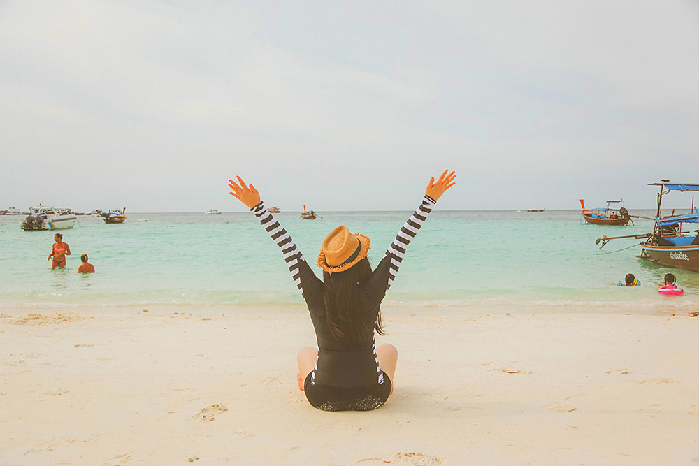 Person enjoying a Thai beach during expat life in Thailand